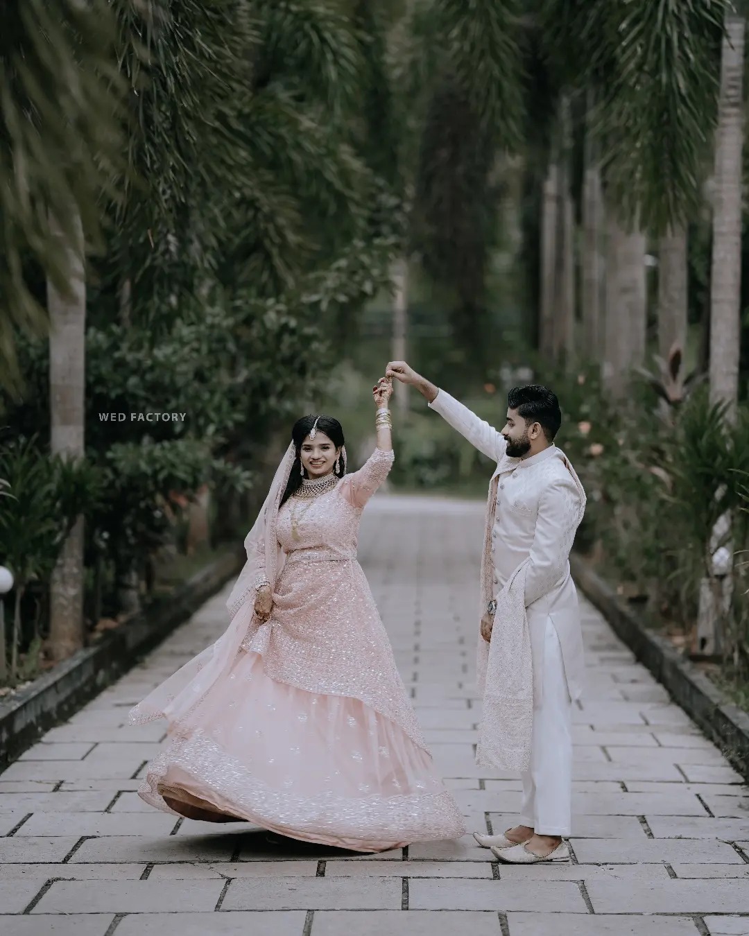 a man and woman dancing on a path